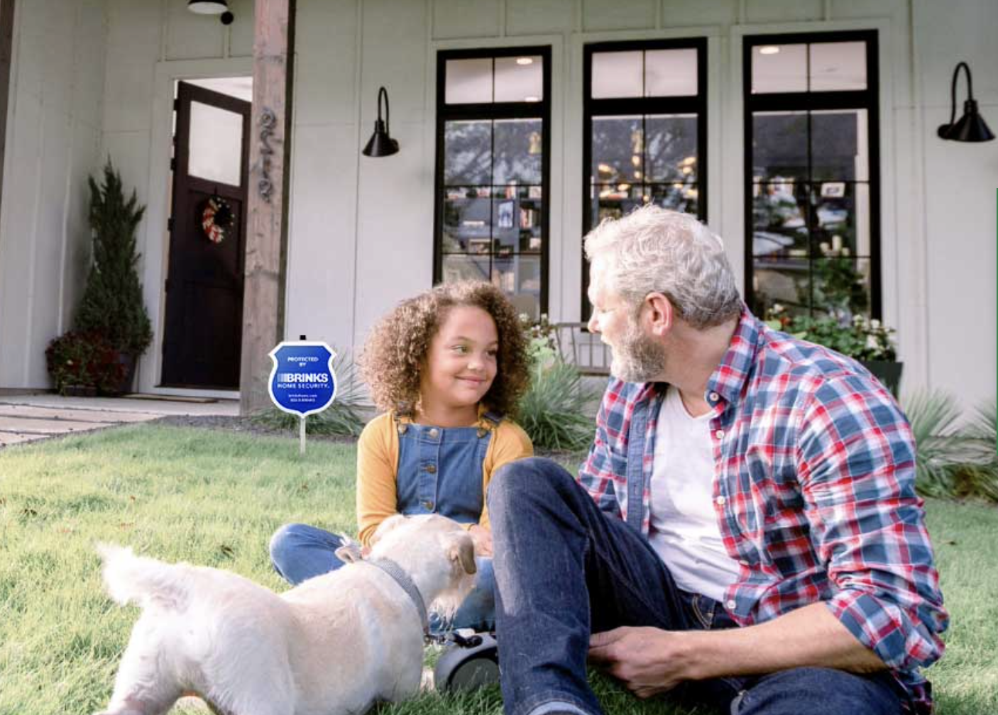 girl, old man, dog, sitting in front of house with Brinks Home Security lawn sign